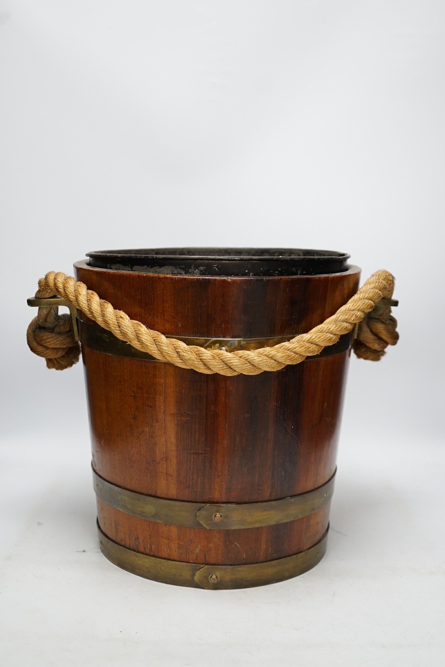 A 19th century naval brass bound painted teak bucket with rope handle, 31cm. Condition - fair